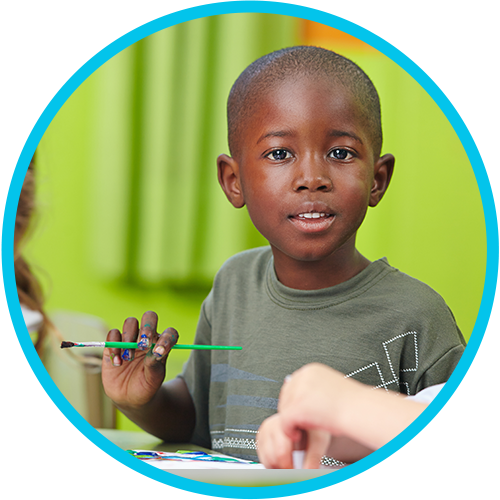 Daycare boy coloring with group