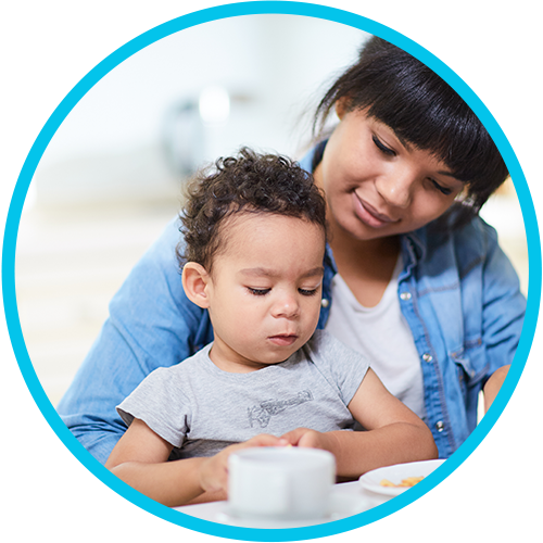 Daycare provider feeding baby